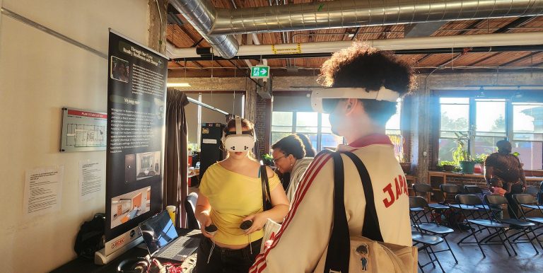 People in a cafe using a VR headset