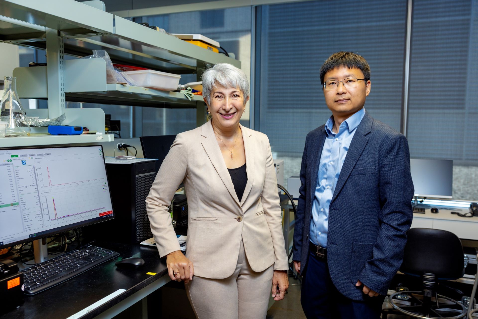 A woman and a man standing in a lab