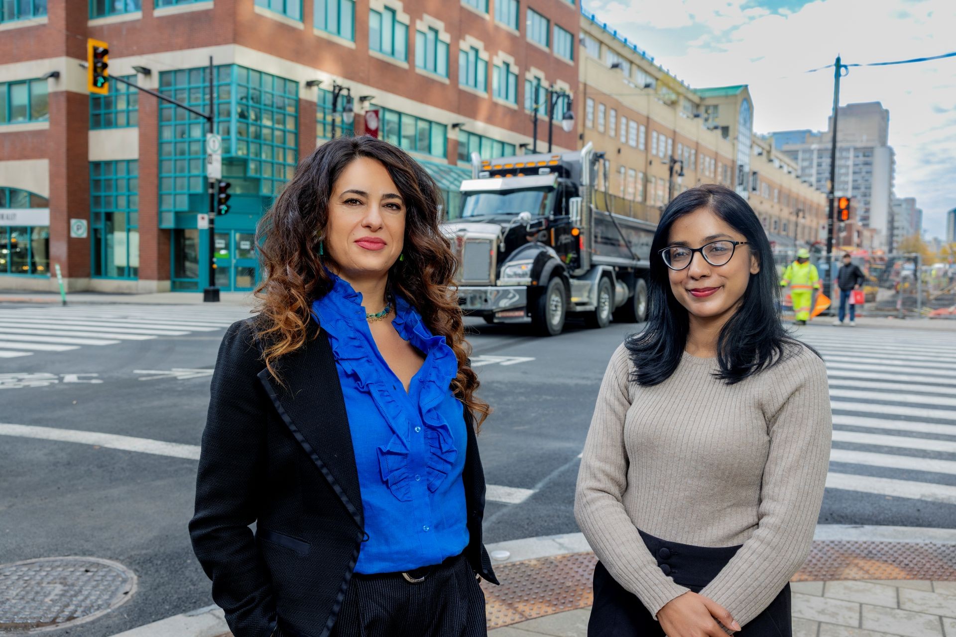 Two female researches standing on a street corner