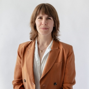 Woman with orange vest smiling