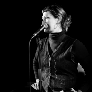 Black and white photo showing woman singing