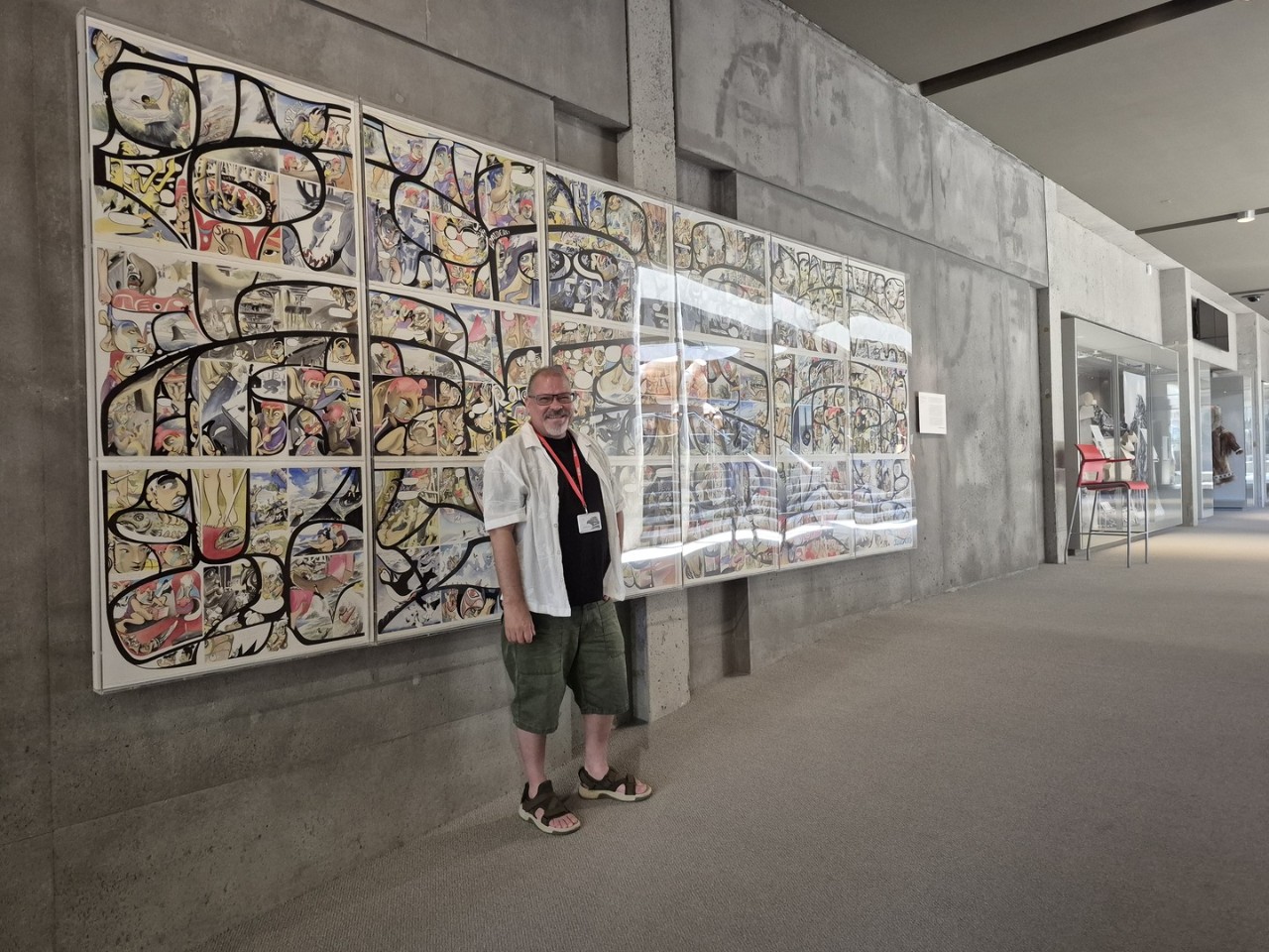 Man in museeum in front of indigenous artwork