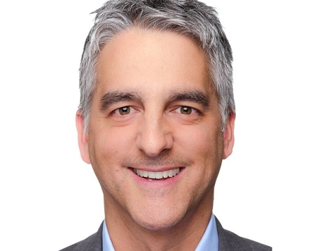 Smiling man with short, grey hair and wearing a blue blazer and light-blue shirt.