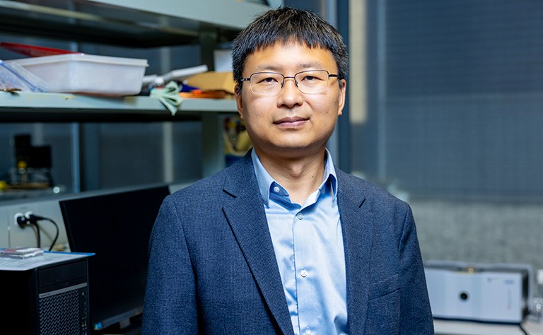 Smiling man in a university engineering interior space